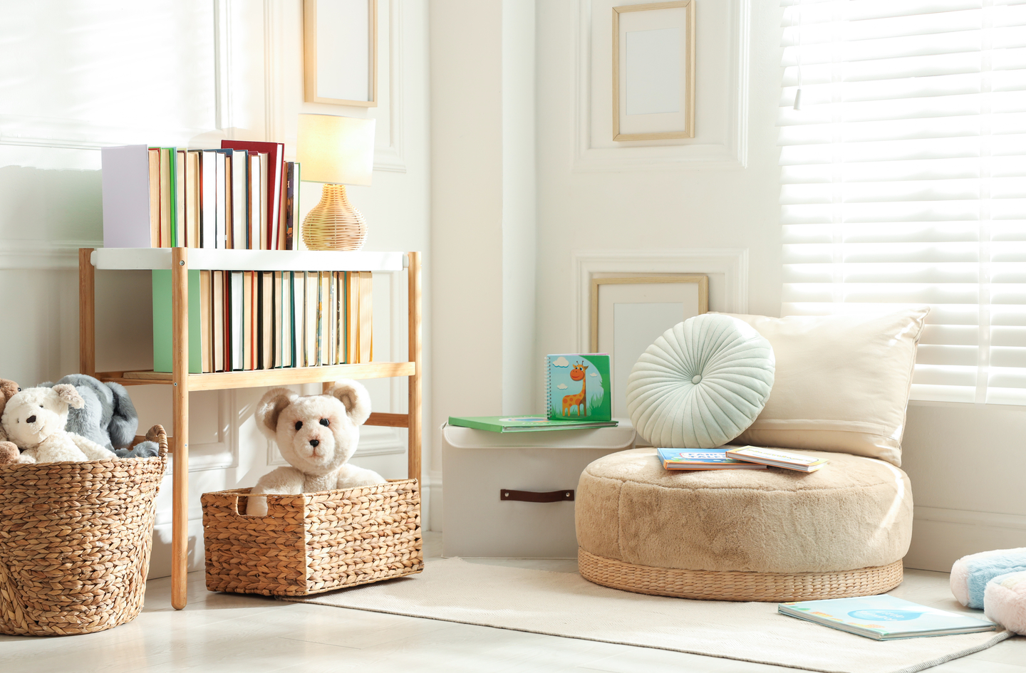 floor cushion reading nook for kids - a round floor pouf with mint accent pillow beside a wooden bookshelf in a bright child's room
